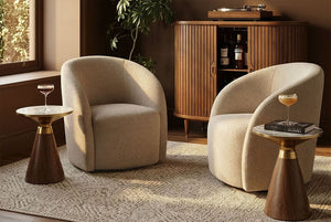 Two Coddle Bromley Swivel Chair with small wooden tables in a room with a wooden cabinet and plant