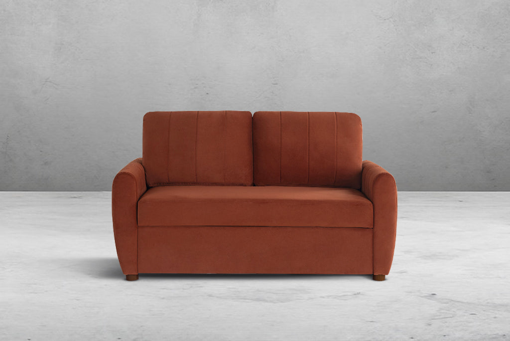 Rust colored Coddle sofa against a gray wall