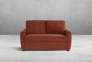 Rust colored Coddle sofa against a gray wall