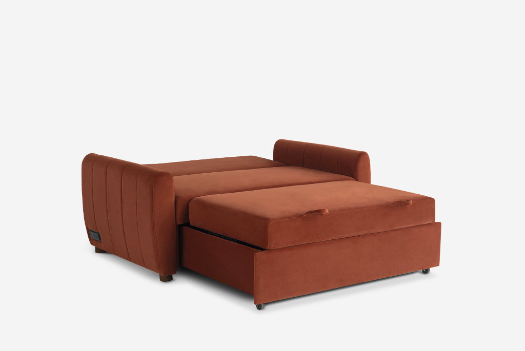 Rust colored Coddle sofa bed on a white background