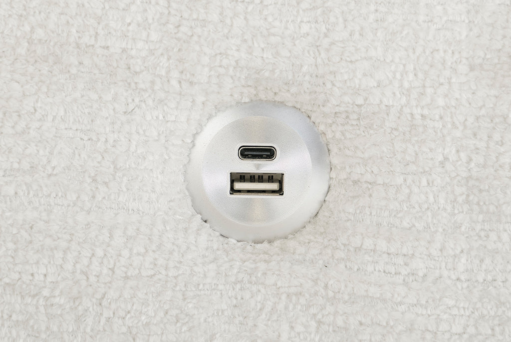 Round metallic USB and micro USB port on a Matrix Queen-Sized Sleeper Sofa