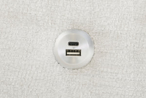Round metallic USB and micro USB port on a Matrix Queen-Sized Sleeper Sofa