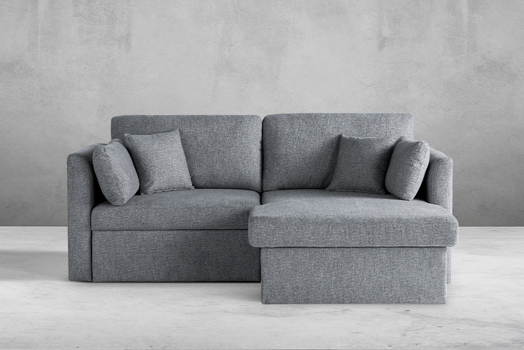 Gray Coddle sectional sofa with cushions against a plain wall