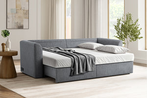 Gray Coddle sofa bed in a modern living room with light wood flooring and large windows