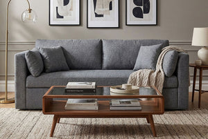 Gray Coddle sofa in a living room with a wooden coffee table and framed art on the wall